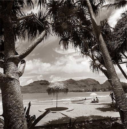 polynesian - MOUNTAINS BEACH RELAXING VACATION SUN SUNSHINE UMBRELLA BOAT CANOE SHORE CLOUDS COUPLE Stock Photo - Rights-Managed, Code: 846-02796763