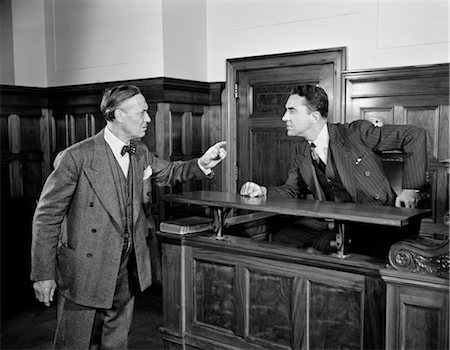 1940s 1950s 2 MEN ATTORNEY LAWYER POINT ARGUE CASE BEFORE JUDGE LAW COURTROOM BENCH LEGAL Stock Photo - Rights-Managed, Code: 846-02796825