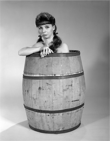 disadvantage - SAD WOMAN PIG TAILS SITTING IN WOODEN BARREL NAKED BARE SHOULDERS DISADVANTAGE 1960s FUNNY CHARACTER SITUATION Stock Photo - Rights-Managed, Code: 846-02796992