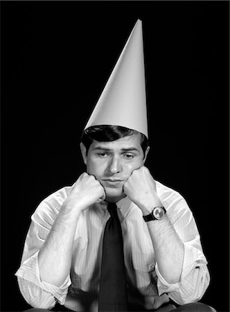 1960s BUSINESS MAN CHARACTER IN SHIRT TIE WEARING CONE SHAPE DUNCE CAP Stock Photo - Rights-Managed, Code: 846-02797049
