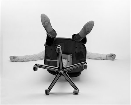 people falling - 1980s MAN ONLY SEE ARMS LEGS BOTTOM OF OFFICE CHAIR FALLEN OVER BACKWARDS Stock Photo - Rights-Managed, Code: 846-02797185