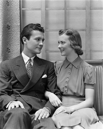 1930 1930s 1940s COUPLE SITTING IN CHAIR ARMS LOCKED Stock Photo - Rights-Managed, Code: 846-02797200