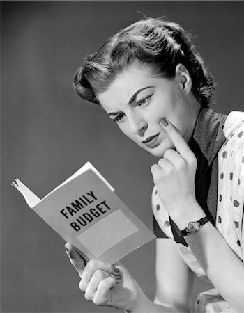 simsearch:846-02797902,k - 1950s WOMAN IN APRON FINGER ON CHEEK LOOKING AT FAMILY BUDGET BOOK Stock Photo - Rights-Managed, Code: 846-02797306