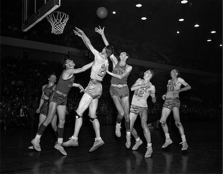 1950s COLLEGE BASKETBALL BALTIMORE WARRIORS PHILADELPHIA BALL IS IN AIR PLAYERS JUMPING UNDER HOOP Stock Photo - Rights-Managed, Code: 846-02797329