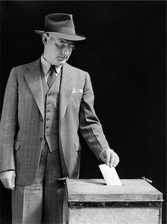 simsearch:846-02796457,k - 1940s MAN PUTTING BALLOT IN BOX Stock Photo - Rights-Managed, Code: 846-02797336
