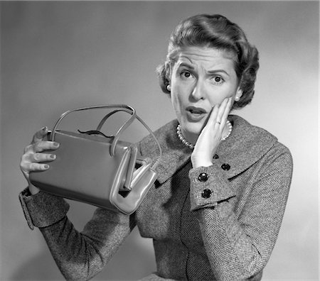simsearch:846-02797888,k - 1950s WOMAN FUNNY SURPRISED OH NO FACIAL EXPRESSION HAND CHEEK LOOK EMPTY HAND BAG POCKETBOOK BROKE Stock Photo - Rights-Managed, Code: 846-02797465
