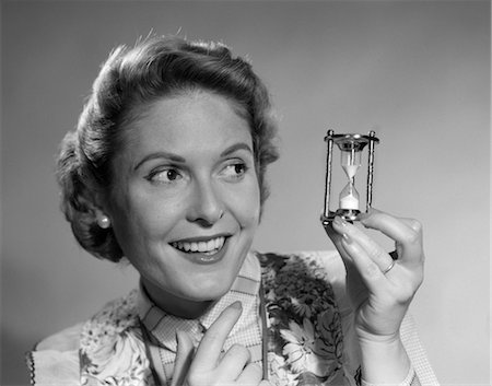 1950s WOMAN HOLDING UP HOURGLASS Stock Photo - Rights-Managed, Code: 846-02797463