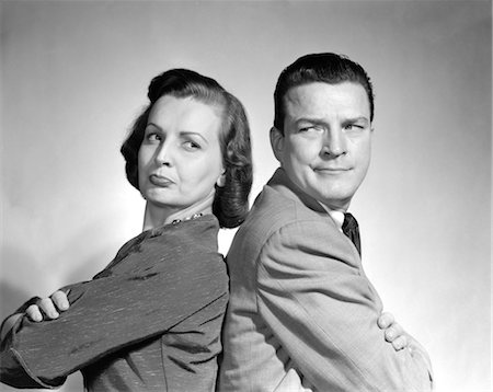 1950s COUPLE SITTING BACK TO BACK ARMS CROSSED ARGUING EXPRESSION Stock Photo - Rights-Managed, Code: 846-02797534