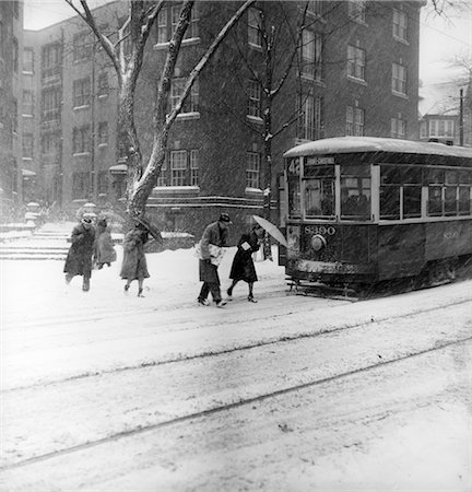 simsearch:846-02797719,k - 1940s CITY WINTER SCENE PEDESTRIANS CROSSING STREET SNOW TROLLEY CAR TRANSPORTATION Stock Photo - Rights-Managed, Code: 846-02797664