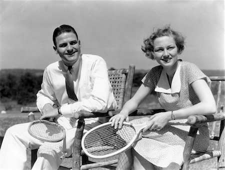 simsearch:846-02797740,k - 1940s MAN AND WOMAN SITTING IN WOODEN CHAIRS EACH HOLDING TENNIS RACQUET RACKET Stock Photo - Rights-Managed, Code: 846-02797667