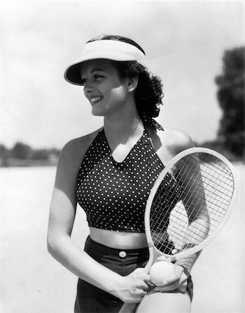 1930s WOMAN IN POKKA DOT HALTER TOP DARK SHORTS & SUN VISOR HOLDING A TENNIS BALL & RACKET Stock Photo - Rights-Managed, Code: 846-02797672