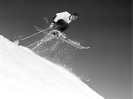 simsearch:846-02797740,k - 1950s MAN SKIER SKIING DOWN SLOPE JUMPING INTO AIR MID-AIR MEN SKIERS SKI SKIS SKIING WINTER SPORTS Stock Photo - Rights-Managed, Code: 846-02797769