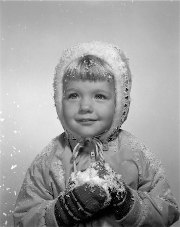 1950s LITTLE GIRL POSING IN WINTER JACKET MITTENS AND HOLDING SNOW Stock Photo - Rights-Managed, Code: 846-02797760