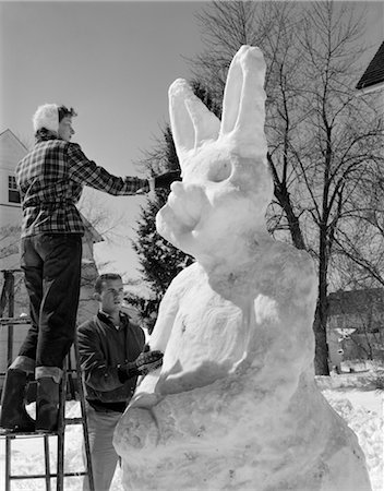 1950s COUPLE OUTSIDE SCULPTING GIANT SNOW BUNNY Stock Photo - Rights-Managed, Code: 846-02797771