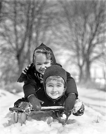 simsearch:846-02796436,k - 1930s BOY AND GIRL ON SLED LOOKING AT CAMERA Stock Photo - Rights-Managed, Code: 846-02797784