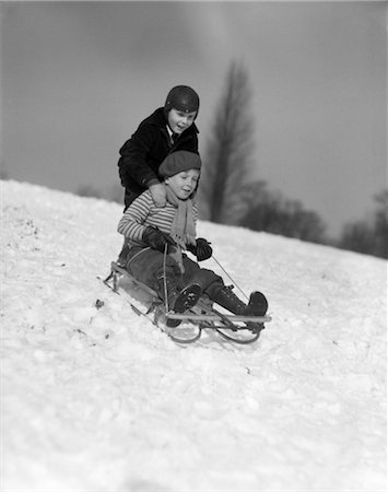 simsearch:846-02796436,k - 1930s TWO BOYS SLEDDING OUTSIDE IN SNOW Stock Photo - Rights-Managed, Code: 846-02797794