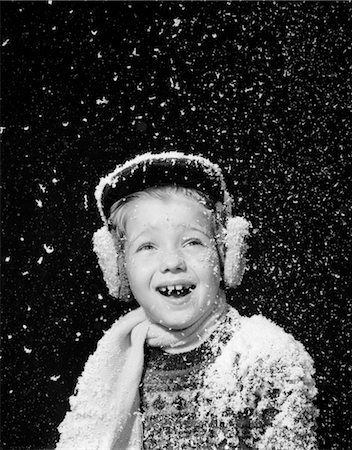 simsearch:846-02796436,k - 1950s BOY CATCHING SNOWFLAKES IN OPEN MOUTH SNOW FALLING EAR MUFFS HAT SCARF IN STUDIO Stock Photo - Rights-Managed, Code: 846-02797839