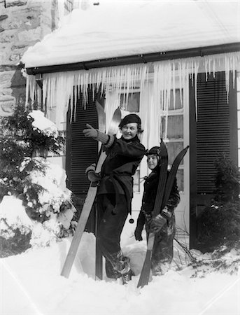simsearch:846-02796436,k - 1930s MOTHER SON STANDING HOLDING SKIS IN FRONT OF WINTER HOUSE WITH ICICLES MOTHER POINTING SNOW Stock Photo - Rights-Managed, Code: 846-02797842