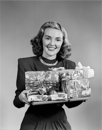 1950s WOMAN HOLDING PILE OF WRAPPED GIFTS SMILING AT CAMERA Stock Photo - Rights-Managed, Code: 846-02797898