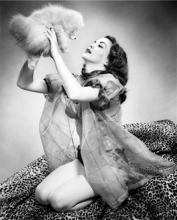 pin up - 1950s YOUNG WOMAN WEARING SEXY LINGERIE KNEELING ON LEOPARD SKIN HOLDING FLUFFY DOG Stock Photo - Rights-Managed, Code: 846-02791882