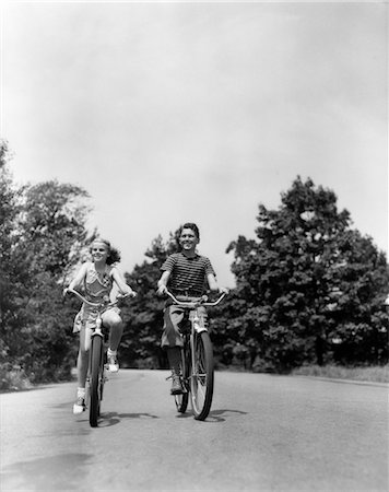 1940s BOY GIRL RIDING BIKES DOWN COUNTRY LANE Stock Photo - Rights-Managed, Code: 846-02791891