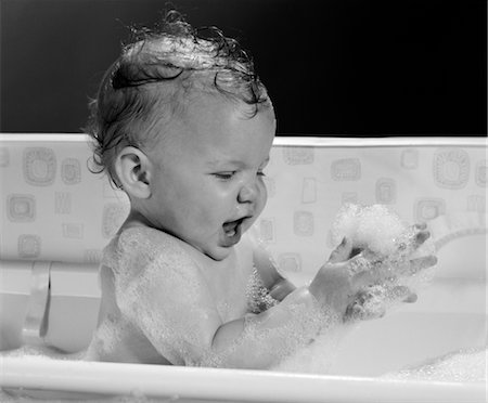 1960s BABY IN BATHTUB PLAYING WITH SUDS INDOOR Stock Photo - Rights-Managed, Code: 846-02791979