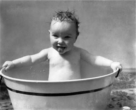 1930s WET BABY IN WASHTUB STICKING OUT TONGUE Stock Photo - Rights-Managed, Code: 846-02792055