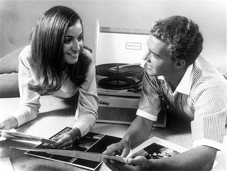 1960s TEEN COUPLE PLAYING LP VINYL RECORDS ON PORTABLE PHONOGRAPH Stock Photo - Rights-Managed, Code: 846-02792146