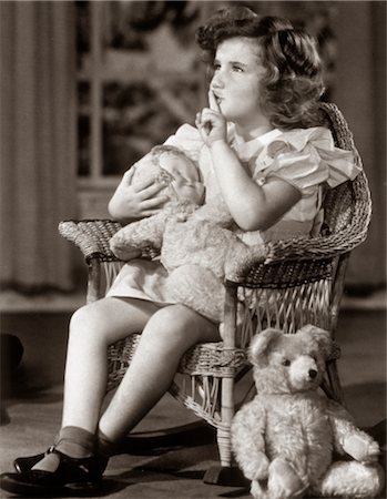 shhh - 1930s 1940s GIRL MAKING SHUSHING SIGN AS SHE ROCKS HER DOLL TO SLEEP IN WICKER ROCKING CHAIR Stock Photo - Rights-Managed, Code: 846-02792177