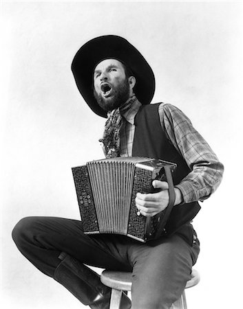 1930s COWBOY PLAYING ACCORDION & SINGING Stock Photo - Rights-Managed, Code: 846-02792217
