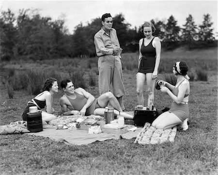 1930s GROUP OF FIVE MEN & WOMEN HAVING PICNIC IN WOODS ALL BUT ONE IN SWIMSUITS Stock Photo - Rights-Managed, Code: 846-02792276