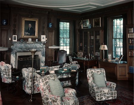 1950s INTERIOR OF LIBRARY ROOM WITH CHINTZ COVERED CHAIRS AND SOFA IN FRONT OF FIREPLACE Stock Photo - Rights-Managed, Code: 846-02792535