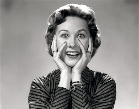 1950s 1960s PORTRAIT OF WACKY WOMAN HANDS ON FACE WITH SMILING EXCITED HAPPY FUNNY FACE SURPRISED EXPRESSION LOOKING AT CAMERA Stock Photo - Rights-Managed, Code: 846-02793041