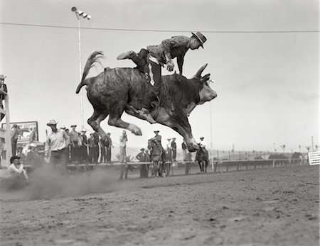 simsearch:846-02793153,k - 1950s COWBOY RIDING BULL JUMPING IN AIR MAN FALLING OFF RODEO RIDER Stock Photo - Rights-Managed, Code: 846-02793156