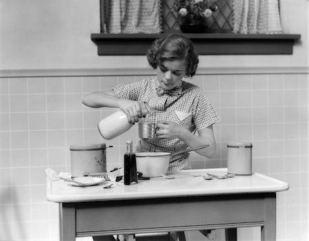 simsearch:846-02793155,k - 1930s TEENAGE GIRL IN KITCHEN POURING MILK IN MEASURING CUP FOR BAKING Stock Photo - Rights-Managed, Code: 846-02793253