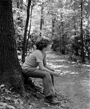 simsearch:846-02796653,k - 1970s SIDE VIEW OF BOY SITTING AT FOOT OF TREE ALONG TRAIL IN WOODS Stock Photo - Rights-Managed, Code: 846-02793528