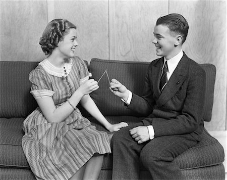 romantic boy and girl - 1930s TEEN BOY & GIRL SITTING ON SOFA HOLDING WISHBONE SMILING WISH ROMANCE DATE Stock Photo - Rights-Managed, Code: 846-02793637