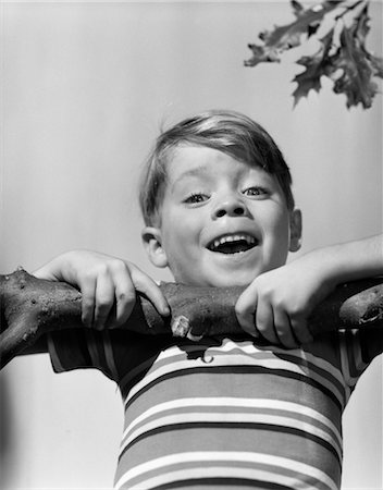 1950s SMILING BOY DOING CHIN-UP ON TREE BRANCH Stock Photo - Rights-Managed, Code: 846-02793663