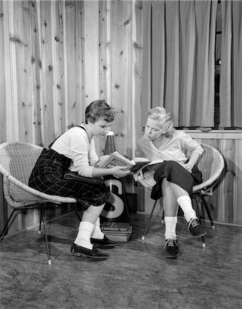 1950s TWO YOUNG TEEN GIRLS SITTING IN STRAW BUCKET CHAIRS READING DOING HOME WORK Stock Photo - Rights-Managed, Code: 846-02793749