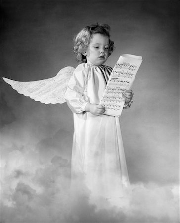 COMPOSITE PHOTO OF GIRL WITH WINGS STANDING IN CLOUDS SINGING WHILE HOLDING SHEET MUSIC WEARING A WHITE SMOCK Stock Photo - Rights-Managed, Code: 846-02793803