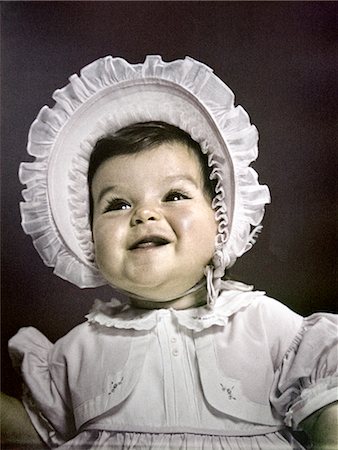 1940s 1950s BABY BRUNETTE PORTRAIT WEAR WHITE RUFFLED DRESS BIG BONNET HAT Stock Photo - Rights-Managed, Code: 846-02793956