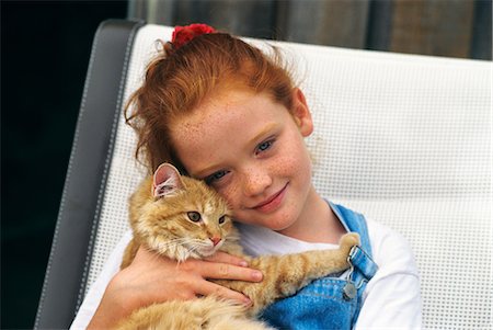 GIRL HOLDING ORANGE TABBY CAT Stock Photo - Rights-Managed, Code: 846-03164029