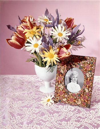 1960s 1970s SPRING BOUQUET TULIPS DAISY WHITE VASE FLOWERED PICTURE FRAME PHOTO OF SENIOR WOMAN STILL LIFE Stock Photo - Rights-Managed, Code: 846-03164486