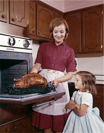 retro cooking - 1960s COOKING TURKEY MOTHER DAUGHTER TURKEY THANKSGIVING Stock Photo - Rights-Managed, Code: 846-03164610