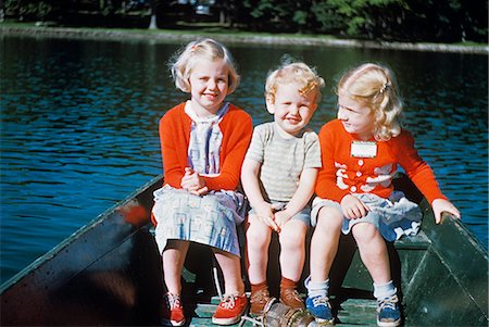1950s BOY AND TWO GIRLS IN RED SWEATERS SITTING IN BACK OF ROWBOAT Stock Photo - Rights-Managed, Code: 846-03164811