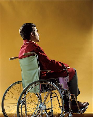 rear of man sitting - 1970s YOUNG MAN FROM BACK SITTING IN WHEELCHAIR Stock Photo - Rights-Managed, Code: 846-03164998