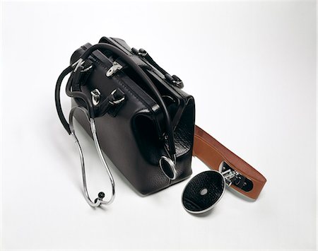 1960s 1970s STILL LIFE BLACK LEATHER DOCTORS BAG STETHOSCOPE EXAMINATION MIRROR HOUSE CALLS Stock Photo - Rights-Managed, Code: 846-03165010