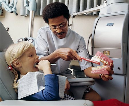 dentistry - 1970s AFRICAN AMERICAN DENTIST TEACHING CHILD HOW TO BRUSH TEETH Stock Photo - Rights-Managed, Code: 846-03165022