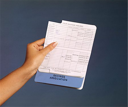 1970s WOMAN'S HAND HOLDING PASSBOOK FOR SAVINGS ACCOUNT Stock Photo - Rights-Managed, Code: 846-03165835