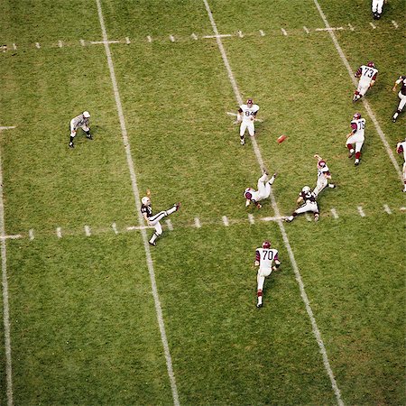 1970s COLLEGE FOOTBALL GAME PLAYER KICKING FOOTBALL ACTION SPORTS Stock Photo - Rights-Managed, Code: 846-03166106